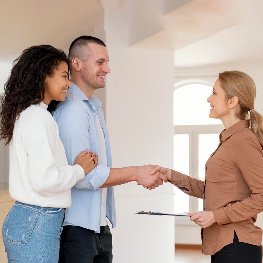 side-view-female-realtor-shaking-hands-with-couple-new-house-deal