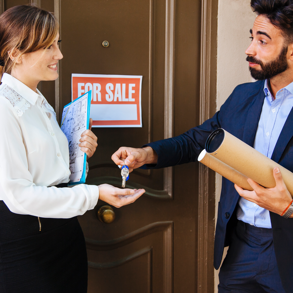 real-estate-agent-giving-key-business-woman